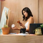 Latin sales clerk scanning a small pot