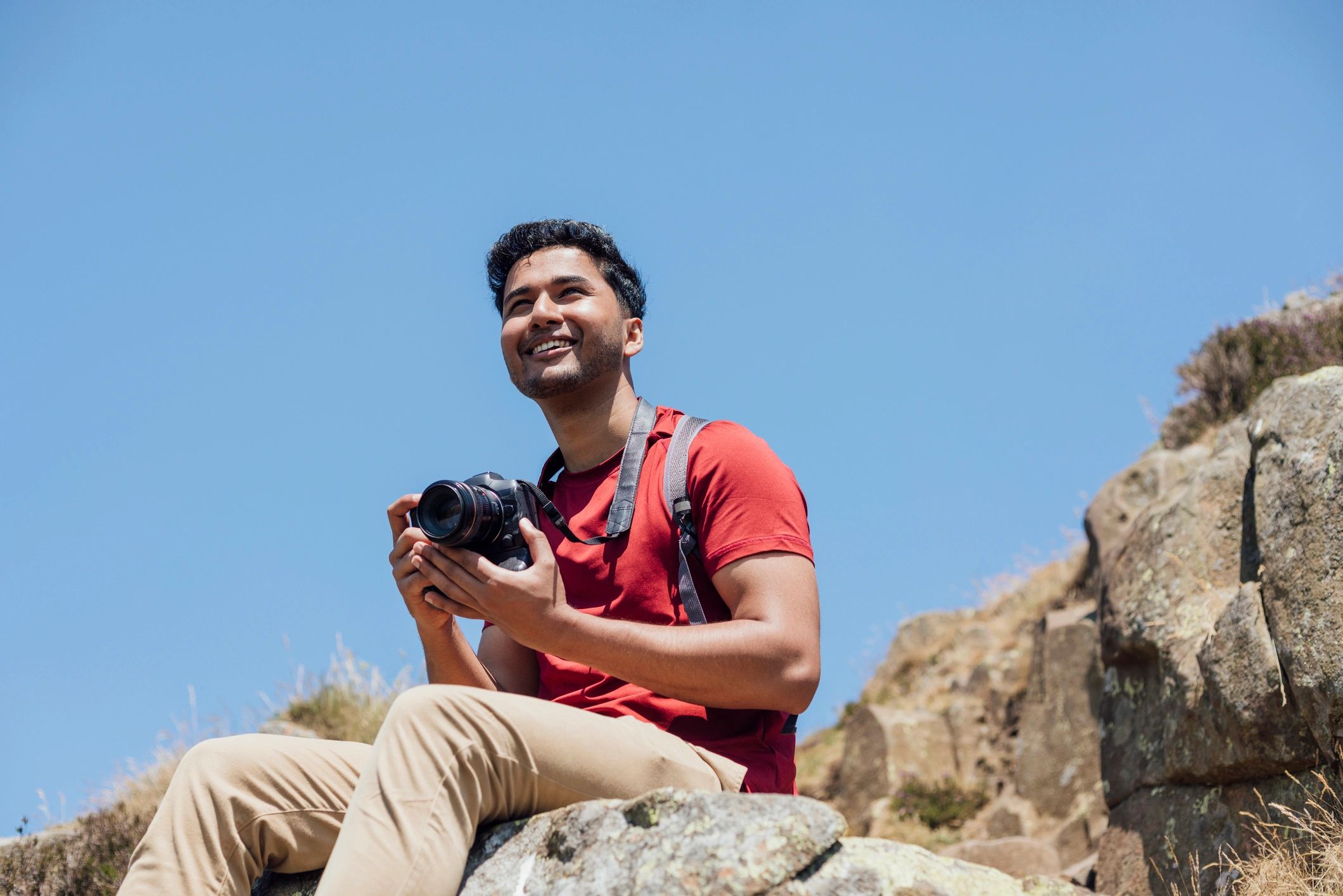 Professional holding a camera outdoors